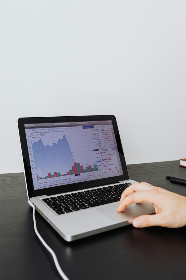 Laptop displaying a cryptocurrency price chart during analysis