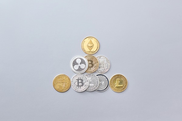 Pyramid arrangement of Ethereum, Bitcoin, Ripple, and Litecoin cryptocurrency coins